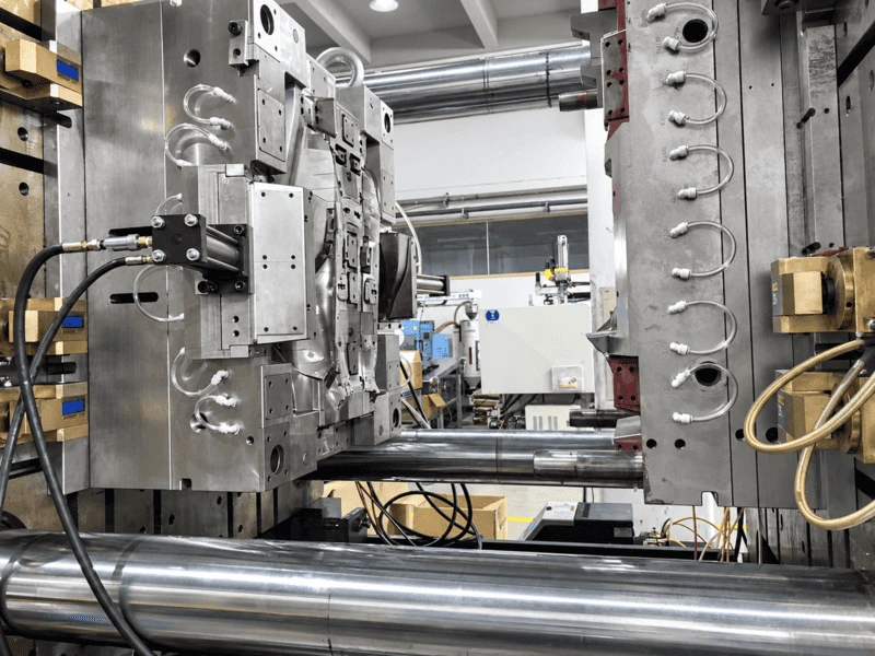 Large plastic injection mold mounted in an injection molding machine for mold trial and setup Large plastic injection mold mounted in an injection molding machine for mold trial and setup